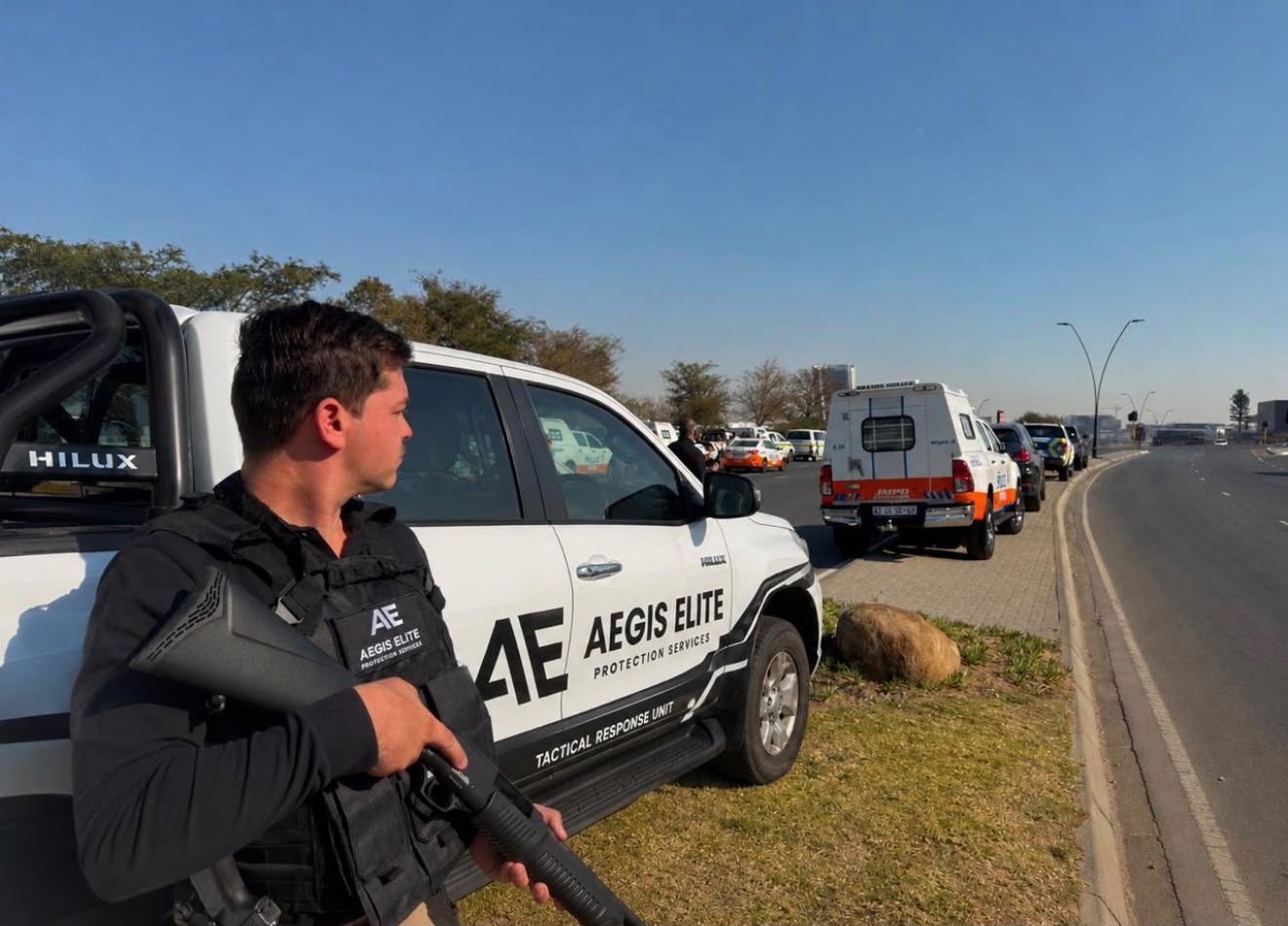AEGIS ELITE tactical response officer alongside a branded response vehicle